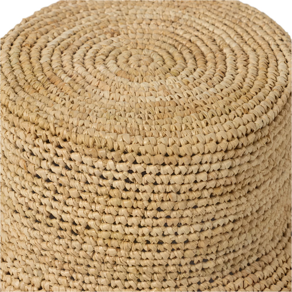 Close-up of a woven beige ottoman with concentric circular pattern.