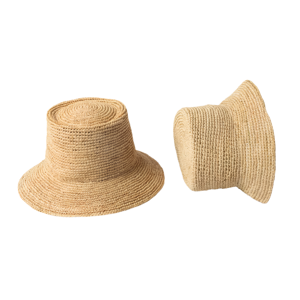 Two woven straw hats on a light gray background
