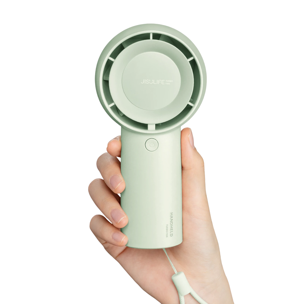 Handheld fan held in a hand on a white background