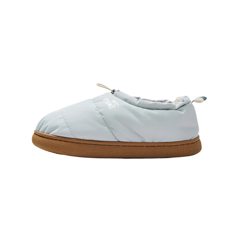 Light blue slip-on shoe with brown sole on a beige background, featuring the brand 'UTUNE'.