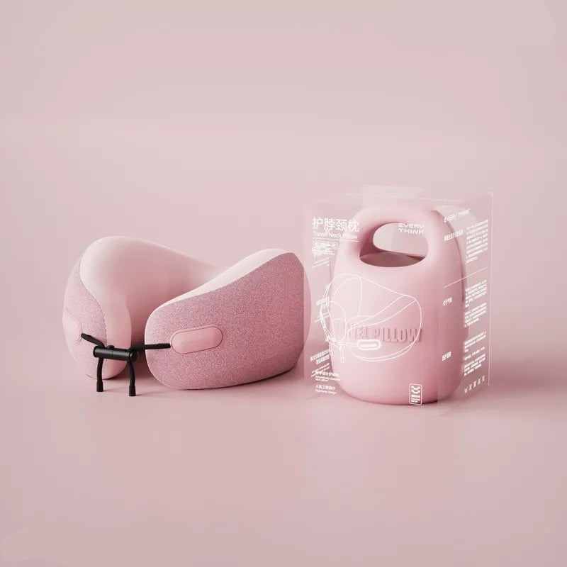 A person is holding a beige U-shaped travel pillow with a removable and washable cover.