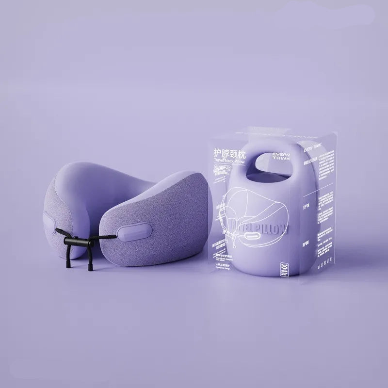 A person is holding a beige U-shaped travel pillow with a removable and washable cover.