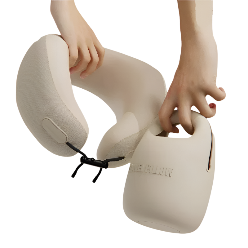 Beige travel neck pillow held by hands on a white background