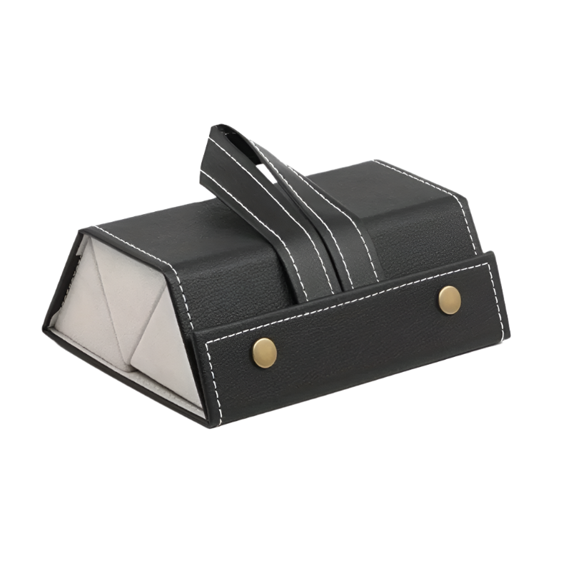 Black leather jewelry box with gold accents on a white background