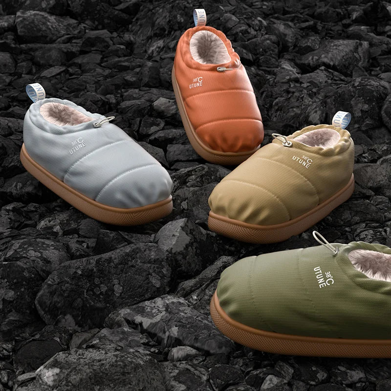Four pairs of colorful slippers on a rocky surface